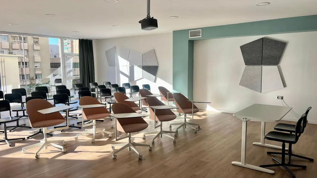 The Cayman Room with training chairs, a projector and natural light